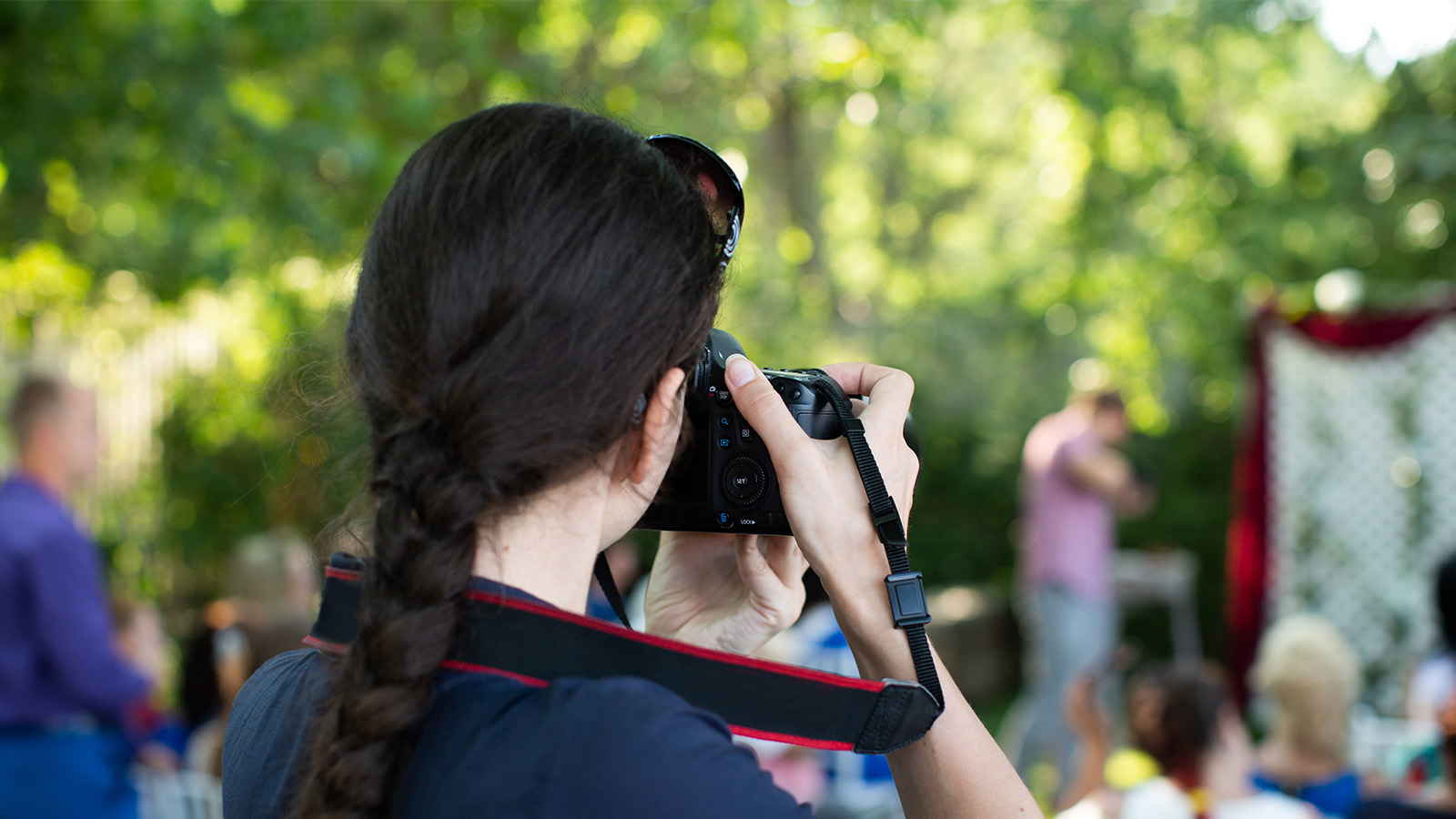 Photographer taking pictures at an outdoor event.
